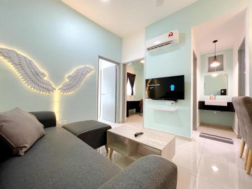 a living room with a couch and a tv at MesaHill Homestay, Nilai by S&T Homez in Nilai