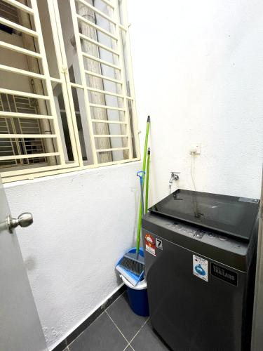 a small refrigerator in a room with a window at MesaHill Homestay, Nilai by S&T Homez in Nilai