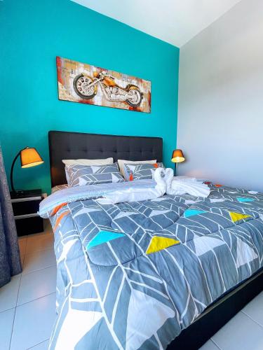 a blue bedroom with a bed with a cat laying on it at MesaHill Homestay, Nilai by S&T Homez in Nilai
