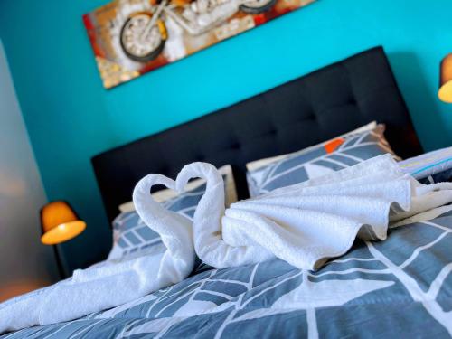 a bed with white towels on top of it at MesaHill Homestay, Nilai by S&T Homez in Nilai