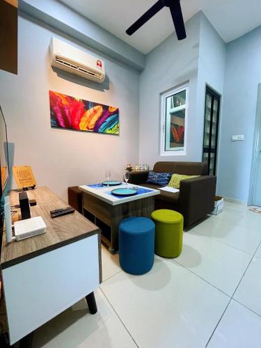 a living room with a couch and a table at MesaHill Homestay, Nilai by S&T Homez in Nilai