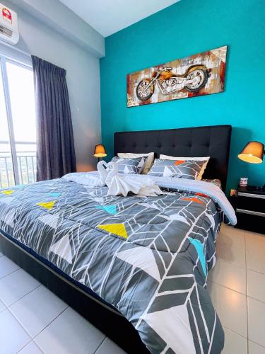 a bedroom with a bed with a motorcycle painting on the wall at MesaHill Homestay, Nilai by S&T Homez in Nilai