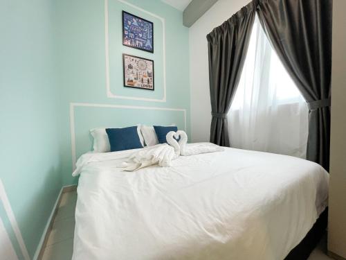 a bedroom with a white bed with swans on it at MesaHill Homestay, Nilai by S&T Homez in Nilai