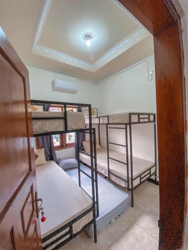 a room with several bunk beds in it at Laura's Backpacker 523 in Yogyakarta