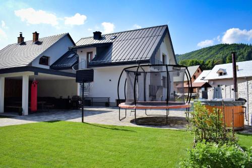 a house with a swing in the yard at Chalupa Martinček in Terchová
