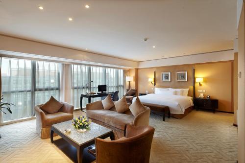 a hotel room with a bed and a couch at The Lakeview Hotel in Beijing