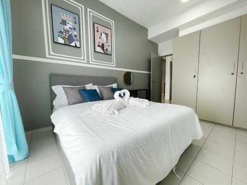 a bedroom with a large bed with white sheets at MesaHill Homestay, Nilai by S&T Homez in Nilai