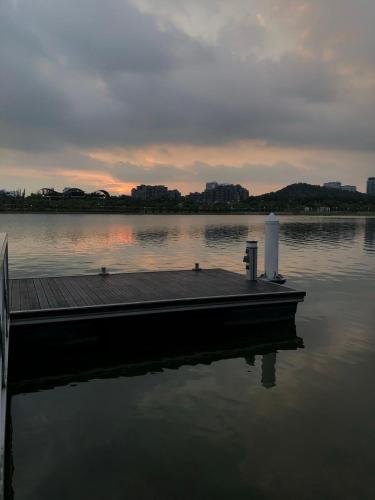 a dock on a body of water with a sunset at La Casa in Cyberjaya
