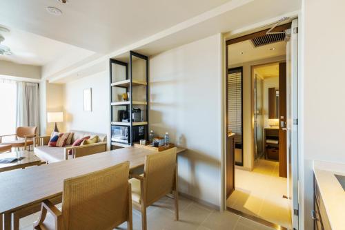 a dining room and living room with a table and chairs at MB GALLERY CHATAN by THE TERRACE HOTELS in Chatan