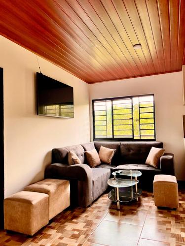 a living room with a couch and a table at El Diamante - Finca Privada con Piscina Barbosa in Barbosa