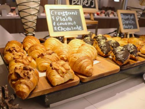 a display of croissants and other pastries in a bakery at Glenmarie Hotel and Golf Resort in Shah Alam