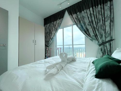 a white bed with a stuffed animal on top of it at MesaHill Homestay, Nilai by S&T Homez in Nilai