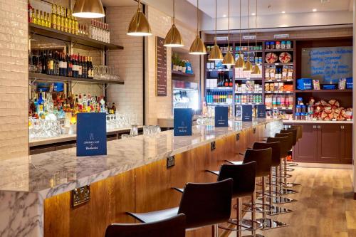 a bar with a row of bar stools at London Marriott Hotel Regents Park in London