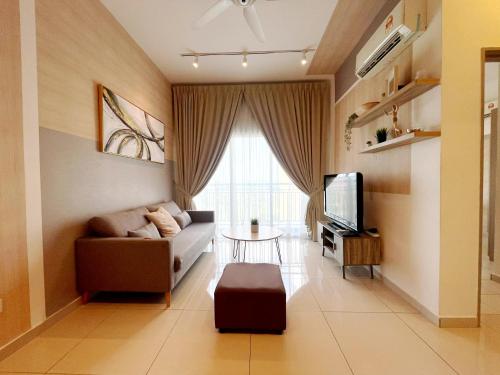a living room with a couch and a tv at MesaHill Homestay, Nilai by S&T Homez in Nilai