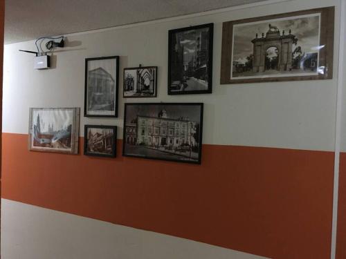 a wall with a bunch of pictures on it at 3 Air Conditioned brs with Office Area, Gated Parking and Free Mini Pool Table in León