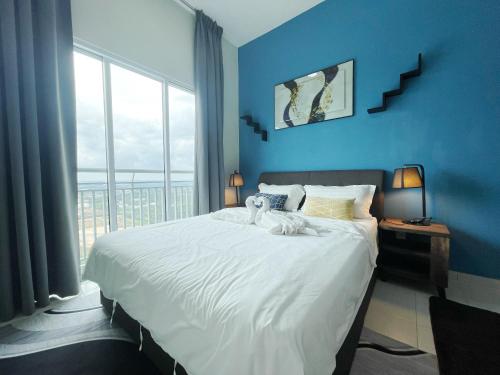 a blue bedroom with a large bed with a window at MesaHill Homestay, Nilai by S&T Homez in Nilai