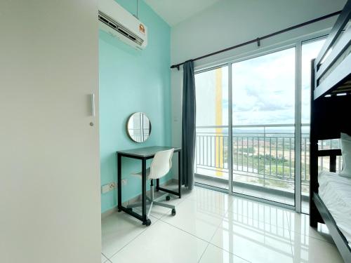 a bedroom with a desk and a large window at MesaHill Homestay, Nilai by S&T Homez in Nilai