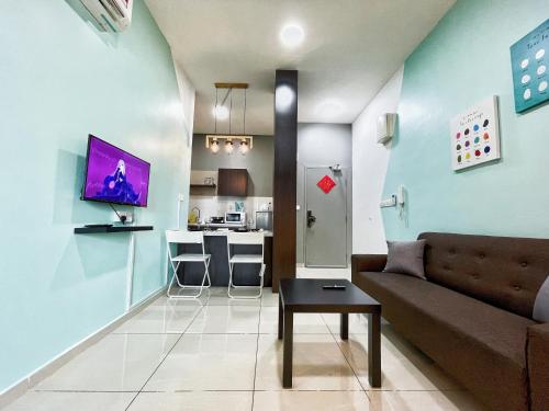 a living room with a couch and a kitchen at MesaHill Homestay, Nilai by S&T Homez in Nilai