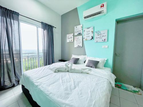 a bedroom with a large white bed with a window at MesaHill Homestay, Nilai by S&T Homez in Nilai