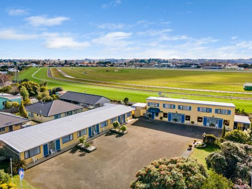 an aerial view of a building and a field at Coachman's Lodge Motel in Whanganui