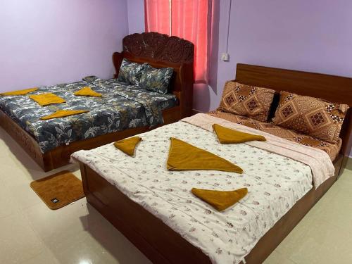 Ένα ή περισσότερα κρεβάτια σε δωμάτιο στο Siem Reap Lodge Eecfc Homestay VSV