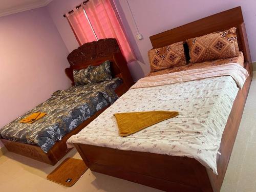 Ένα ή περισσότερα κρεβάτια σε δωμάτιο στο Siem Reap Lodge Eecfc Homestay VSV