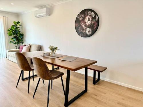 a dining room table and chairs in a living room at Henderson - 4-Bedrooms Home in Auckland