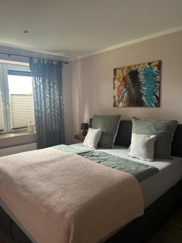 a bedroom with a large bed and a window at Ferienwohnungen mit Feldblick in Schwerin