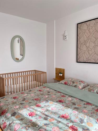 a bedroom with a bed and a mirror on the wall at Casa Luz in Luz