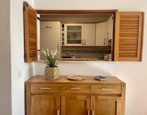 a kitchen with wooden cabinets and a potted plant on a counter at Casa Luz in Luz