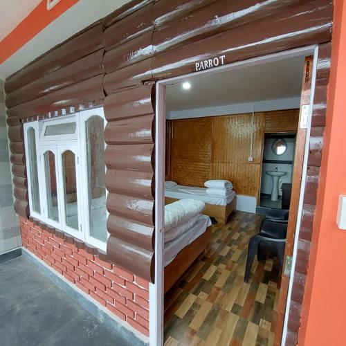 a room with two beds in a brick wall at The Jungle - RISHOP in Rishop