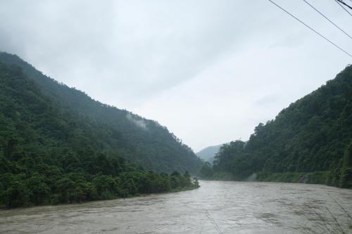 a river in the middle of a valley with trees at The Jungle - RISHOP in Rishop