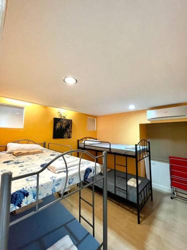 a room with three bunk beds in a room at Winland Tower 1 Condominium in Cebu City