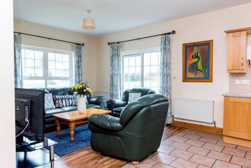a living room with a couch and a television at Portbeg Holiday Homes at Donegal Bay in Bundoran