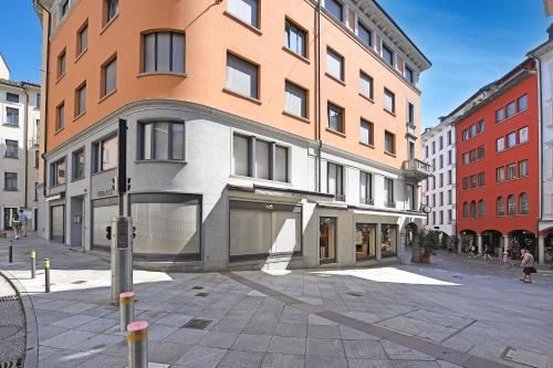 a building on a street in a city at Novos Central Apartments in Lugano