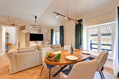 a dining room and living room with a table and chairs at Novos Central Apartments in Lugano