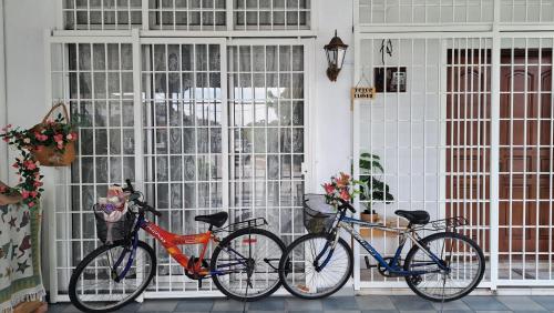 three bikes parked in front of a window at Good Old Days Butterworth Homestay near Raja Uda in Butterworth