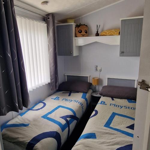 a bedroom with two beds in a room at Skipsea sands Northfield corner in Ulrome