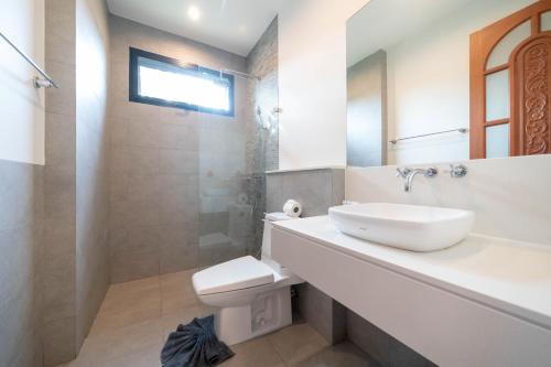 a bathroom with a sink and a toilet and a shower at Peykaa Estate Pool Villa by HCR in Phuket Town