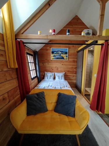 a bedroom with a bed and a couch in a room at La Plaisance sur Ciel in Cordes-sur-Ciel