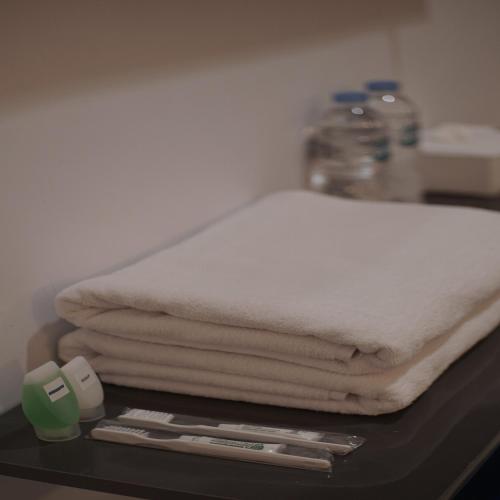a pile of white towels sitting on a table at Hotel Permata Zamrud in Cirebon
