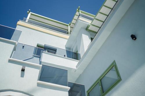 a white building with stairs on the side of it at Karnayo apartments in Kavala