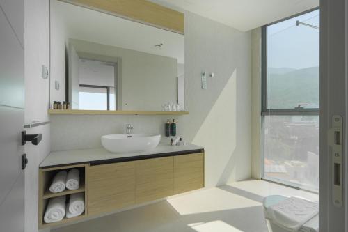 a bathroom with a sink and a mirror at Sea Star Budva in Budva
