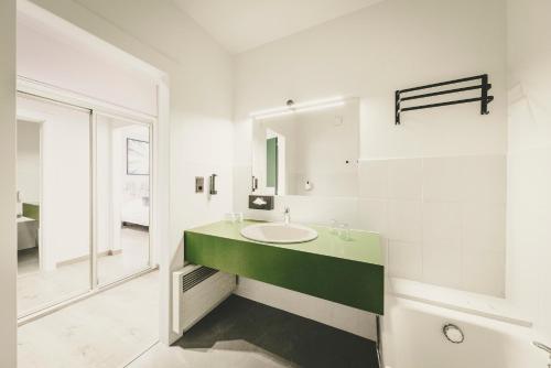 a bathroom with a sink and a mirror at Fleur De Neige Châtel in Châtel