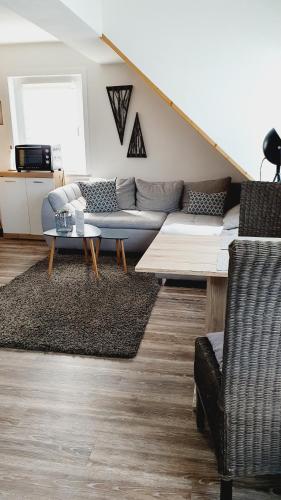 a living room with a couch and a table at Ferienwohnungen Naturzeit in Willingen
