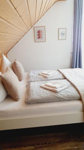 a bedroom with a bed with a wooden ceiling at Ferienwohnungen Naturzeit in Willingen