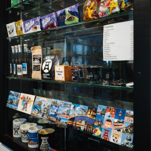 a display case in a store with books and other items at Hotel Mirage in Duisburg