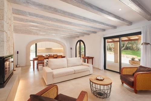 a living room with a couch and a table at Finca Ses Rotes in Cala Ferrera