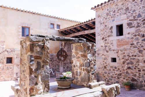 an entrance to a stone building with a potted plant at Agroturisme Sant Dionis in Campllong
