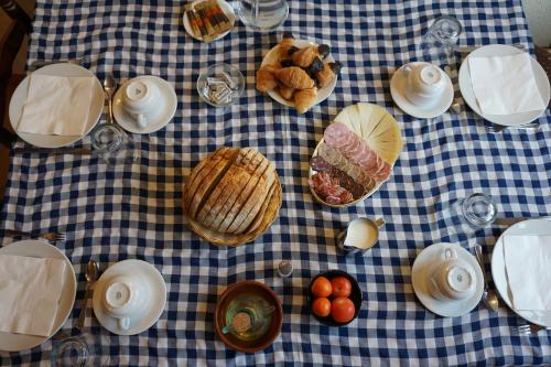 a table with food on a blue and white checked table cloth at Agroturisme Sant Dionis in Campllong